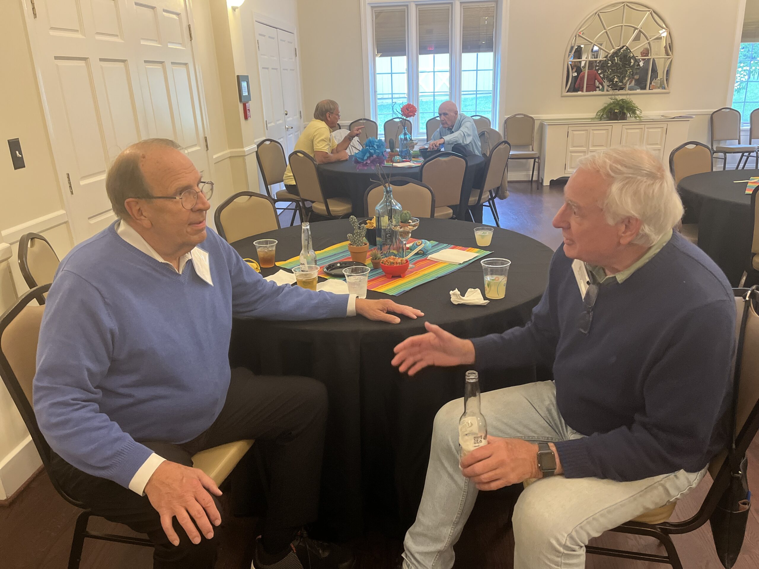 Annual Meeting 5/5/2024. Board member Hank Griffith and Bob Krizansky discussing important matters. (Or perhaps beer?)